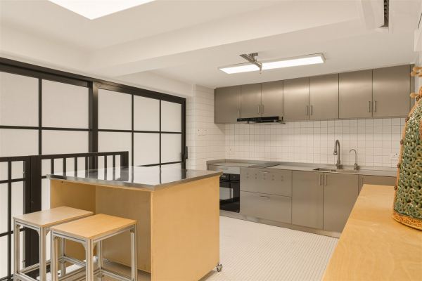 Stainless steel kitchen with plywood island